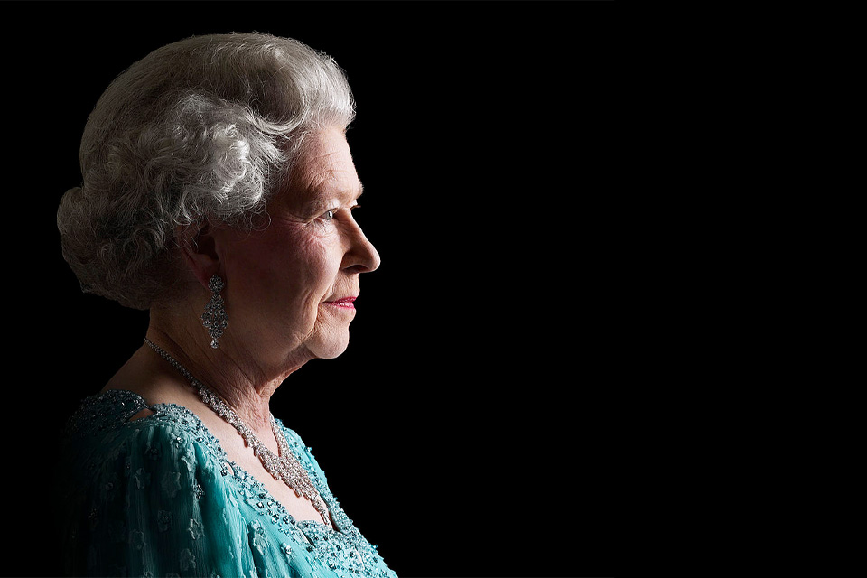 An image of Her Majesty The Queen Elizabeth II in portrait against a black background.